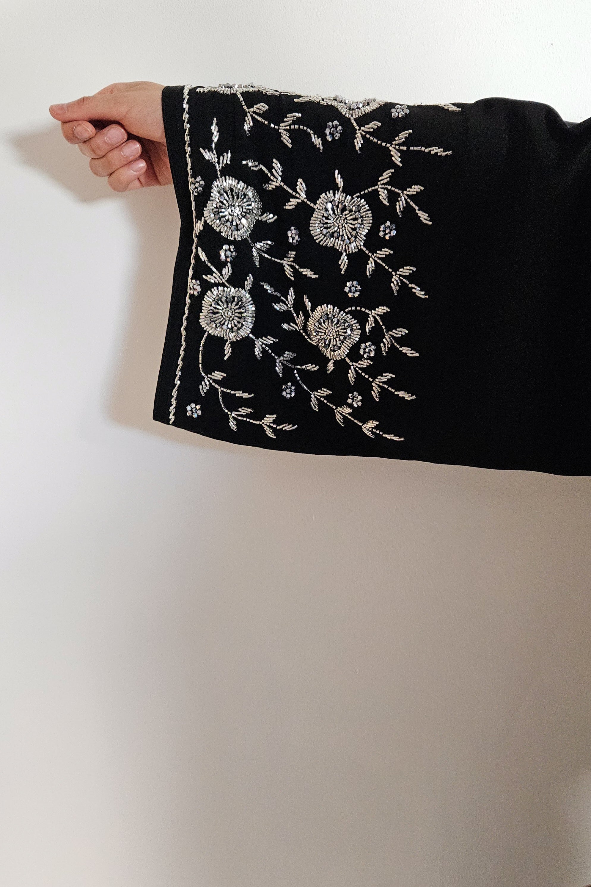 Black abaya with heavy silver embellishments on korean nida, open and closed